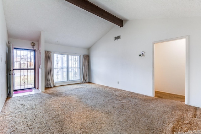 unfurnished living room with vaulted ceiling with beams, a textured ceiling, and carpet flooring