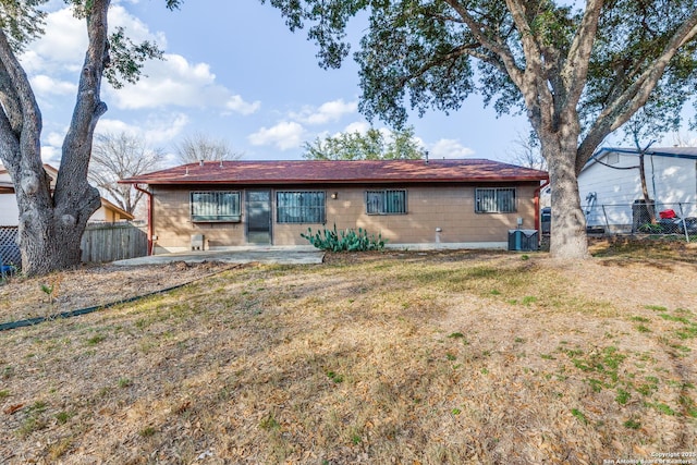 back of house featuring cooling unit, a yard, and a patio area