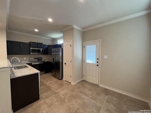 kitchen featuring light stone countertops, appliances with stainless steel finishes, ornamental molding, and sink