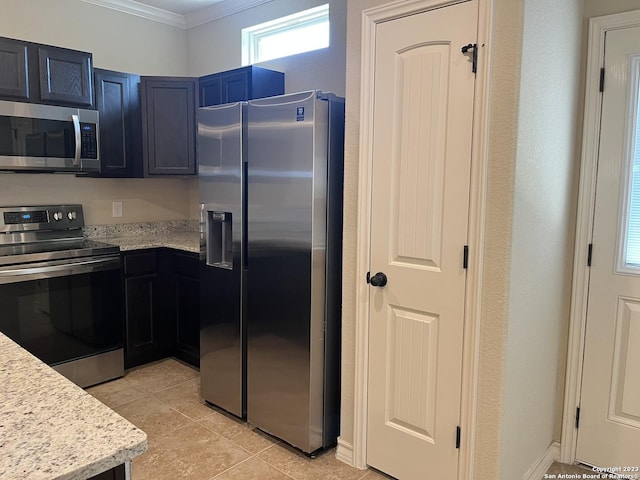 kitchen featuring light stone counters, light tile patterned floors, appliances with stainless steel finishes, and crown molding