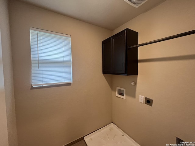 washroom featuring gas dryer hookup, electric dryer hookup, hookup for a washing machine, and cabinets