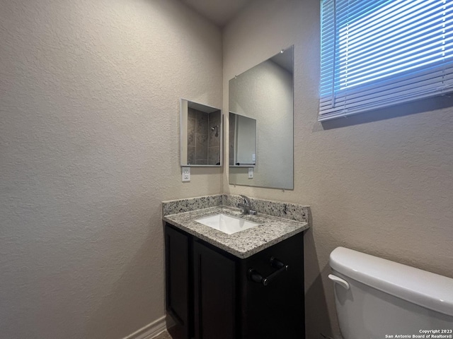 bathroom featuring toilet and vanity