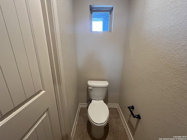 bathroom featuring toilet and tile patterned floors