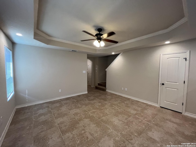 spare room with a raised ceiling, ceiling fan, and crown molding