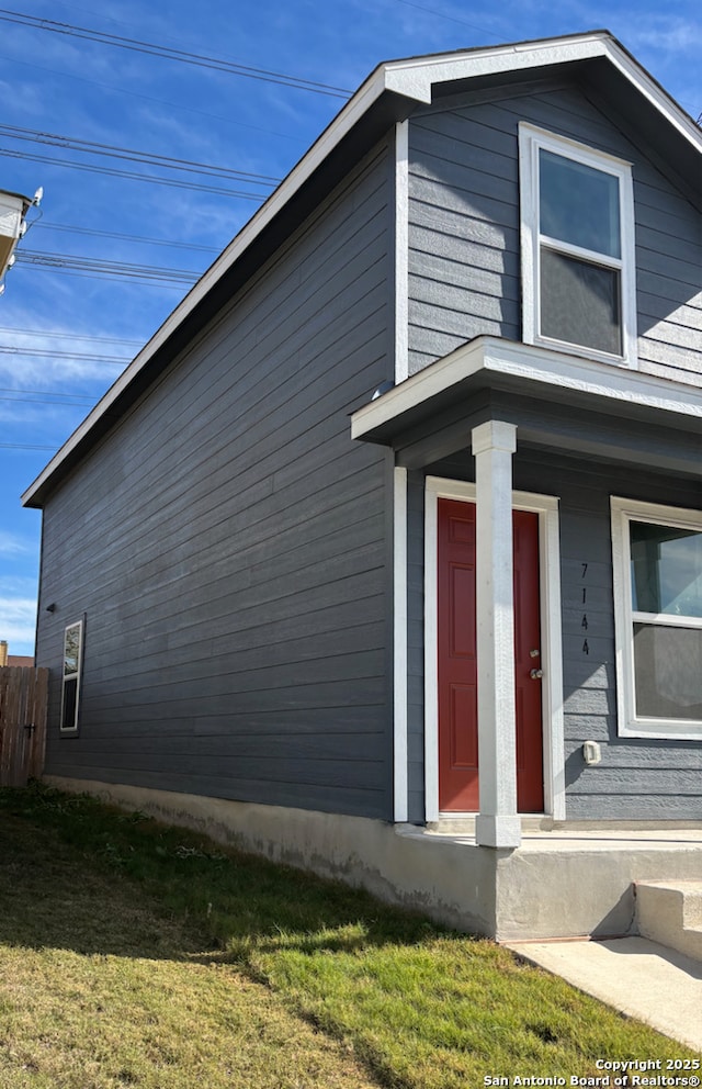 view of side of property featuring a yard