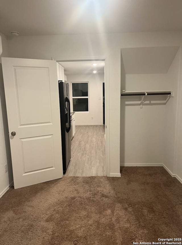 washroom featuring light carpet