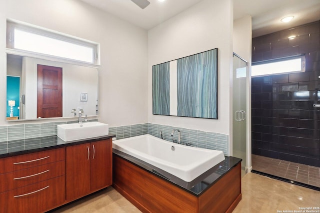 bathroom with separate shower and tub and vanity