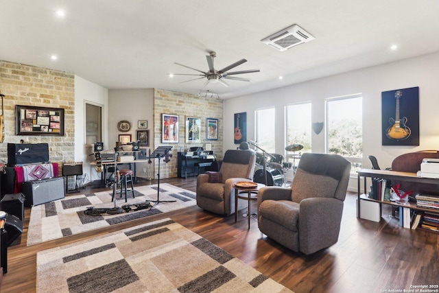 living room featuring ceiling fan and dark hardwood / wood-style flooring