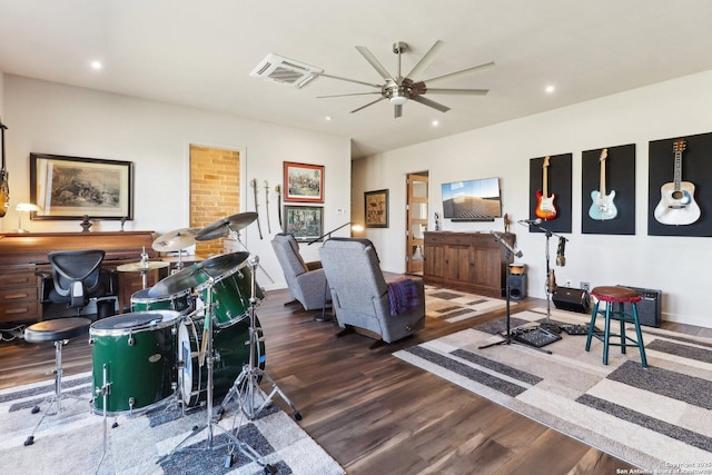 living room with ceiling fan and dark wood-type flooring