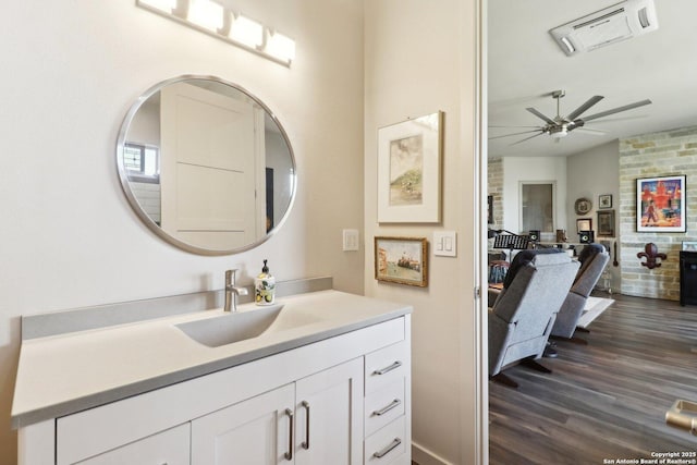 bathroom featuring ceiling fan, hardwood / wood-style floors, and vanity