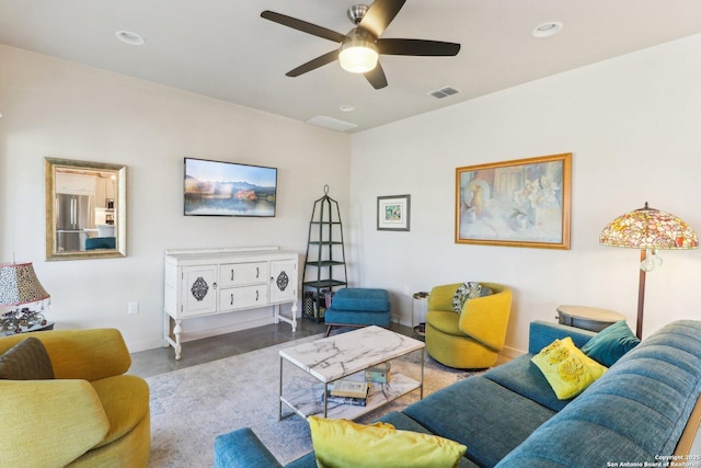 living room featuring ceiling fan and concrete flooring