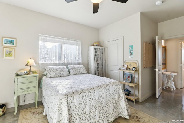 bedroom with ceiling fan and concrete floors