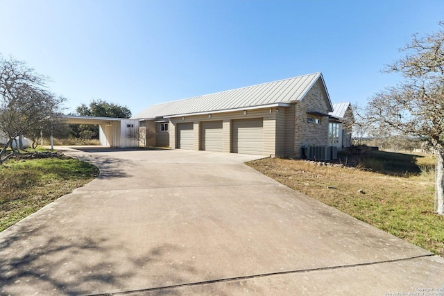 view of front of home with central AC unit and a carport