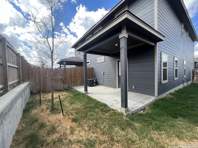 view of home's exterior with a patio area and a lawn