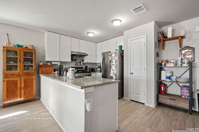 kitchen featuring white cabinetry, stone counters, kitchen peninsula, and appliances with stainless steel finishes