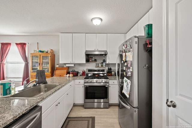 kitchen featuring stainless steel appliances, white cabinets, and sink