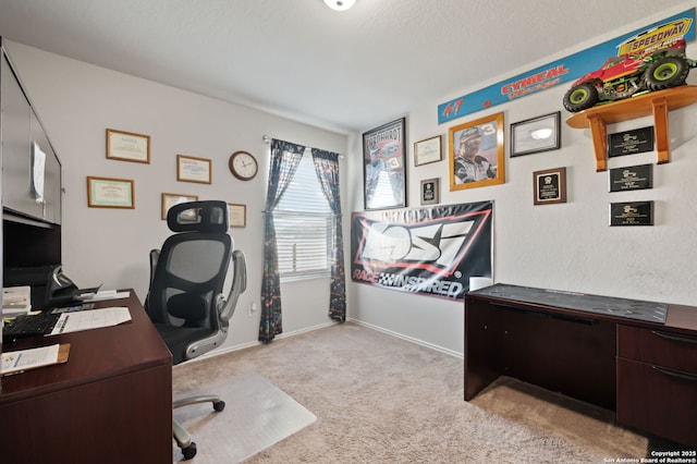 office featuring a textured ceiling and light colored carpet