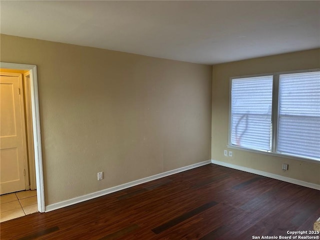 spare room featuring wood-type flooring