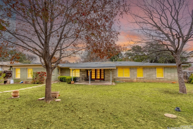 single story home featuring a yard and a patio area