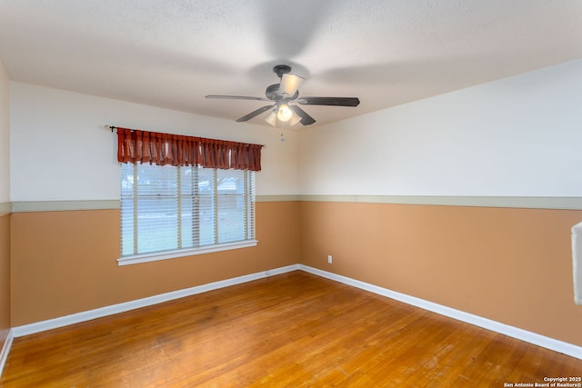 spare room featuring hardwood / wood-style floors and ceiling fan