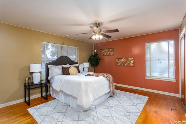 bedroom with ceiling fan and light hardwood / wood-style flooring