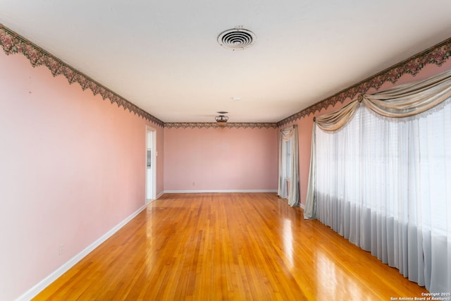 spare room featuring wood-type flooring