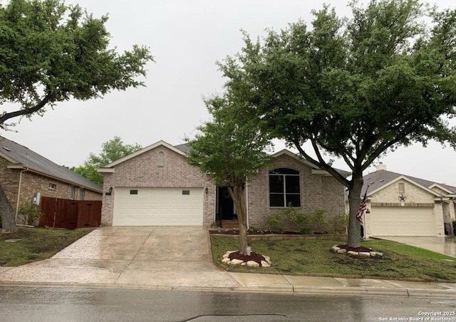 single story home featuring a garage and a front lawn