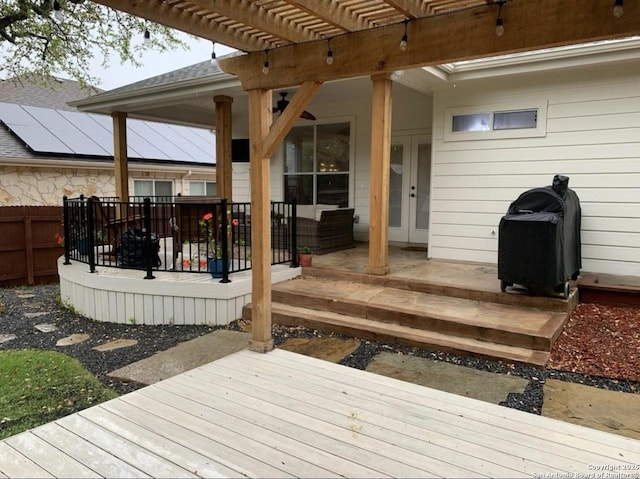 deck featuring french doors and a pergola