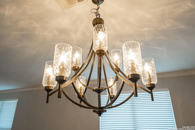 interior details with ornamental molding and a chandelier