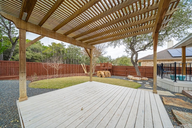 wooden terrace featuring a yard and a pergola