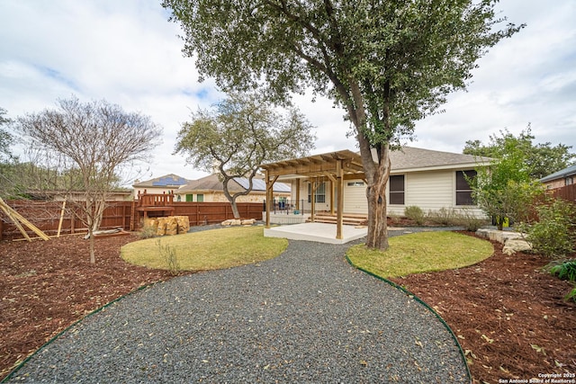 back of house with a patio, a lawn, and a pergola