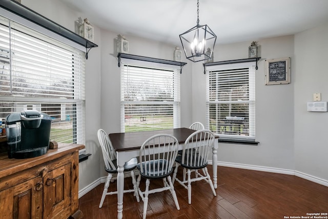 dining room featuring dark wood-type flooring and an inviting chandelier