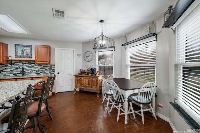 dining room featuring sink and an inviting chandelier