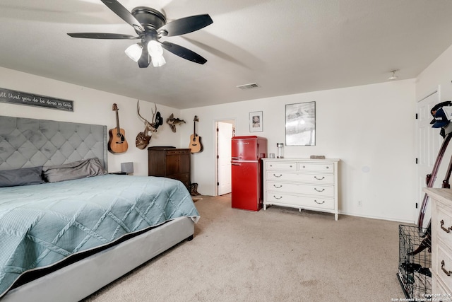 carpeted bedroom with refrigerator and ceiling fan