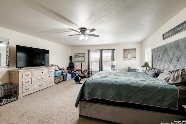 bedroom featuring carpet flooring, a textured ceiling, and ceiling fan