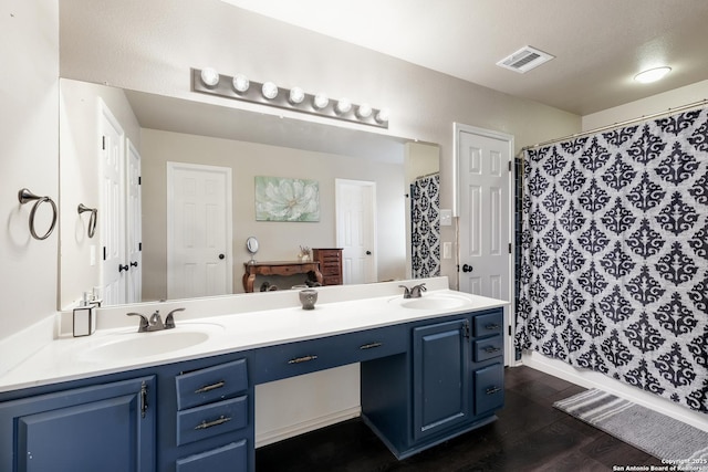 bathroom featuring a textured ceiling, vanity, and hardwood / wood-style flooring