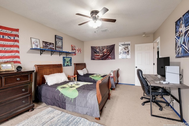 bedroom with light carpet, ceiling fan, and a textured ceiling