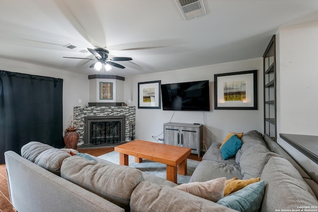 living room featuring ceiling fan and light hardwood / wood-style flooring