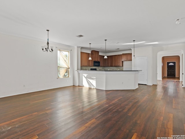 kitchen with a chandelier, dark hardwood / wood-style floors, decorative light fixtures, tasteful backsplash, and ornamental molding