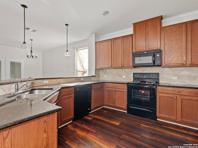 kitchen featuring hanging light fixtures, a notable chandelier, black appliances, dark hardwood / wood-style flooring, and sink