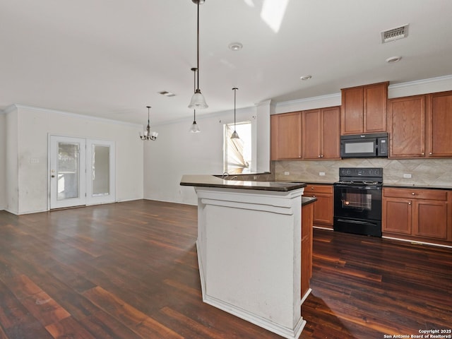 kitchen featuring black appliances, a chandelier, decorative light fixtures, and dark hardwood / wood-style floors