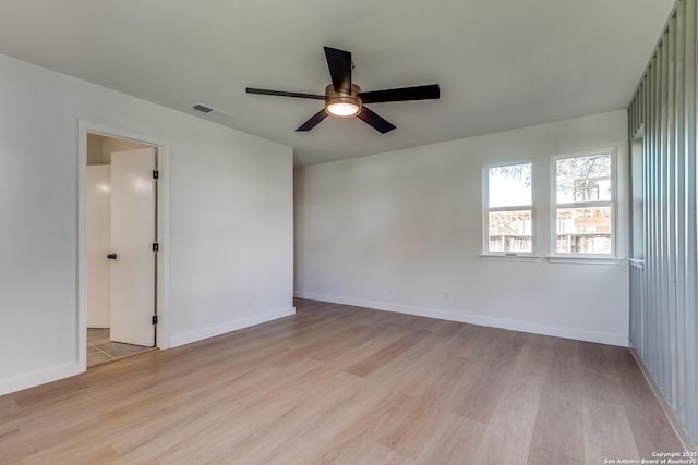 empty room featuring ceiling fan and light hardwood / wood-style floors