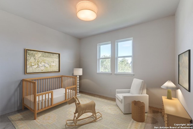 carpeted bedroom featuring a crib