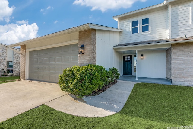 view of front of house featuring a front lawn and a garage