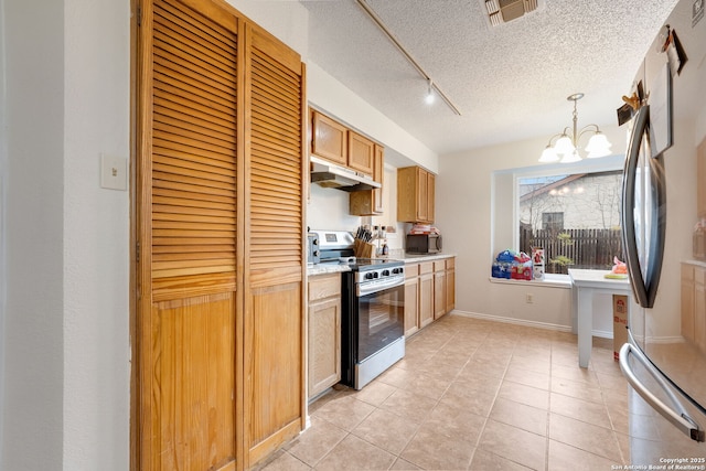 kitchen with a chandelier, stainless steel appliances, hanging light fixtures, light tile patterned floors, and a textured ceiling