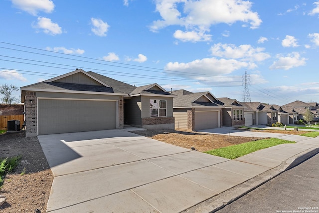 ranch-style home featuring a garage and central AC unit