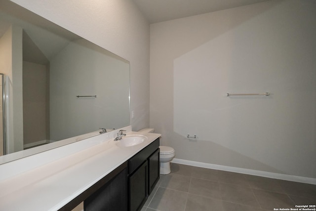 bathroom featuring tile patterned flooring, vanity, and toilet