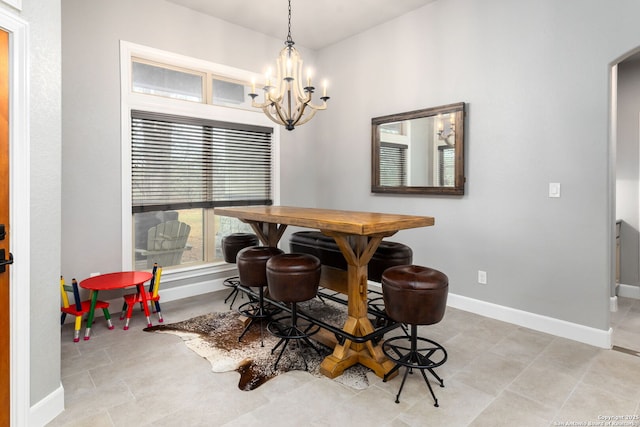 tiled dining space featuring a notable chandelier