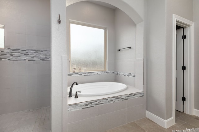 bathroom with tile patterned flooring and plus walk in shower