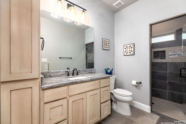 bathroom with toilet, tile patterned flooring, a shower with door, and vanity